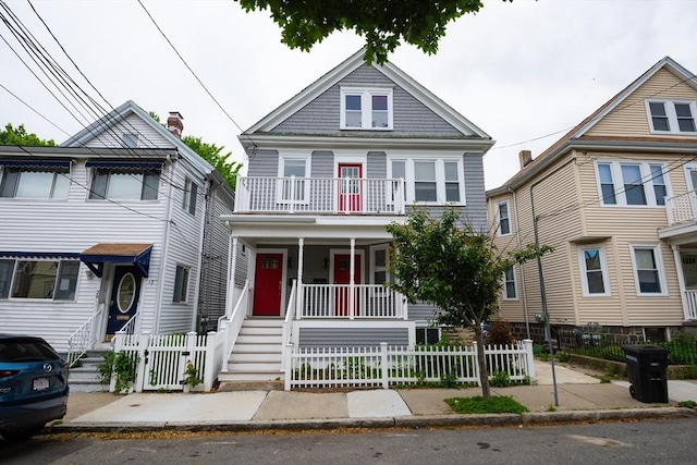 30 Partridge Ave, Somerville, MA 02145 - traditional style home featuring a porch, a fenced front yard, and a balcony