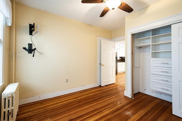 30 Partridge Ave, Somerville, MA 02145 - unfurnished bedroom featuring radiator heating unit, dark wood-style flooring, a closet, and ceiling fan