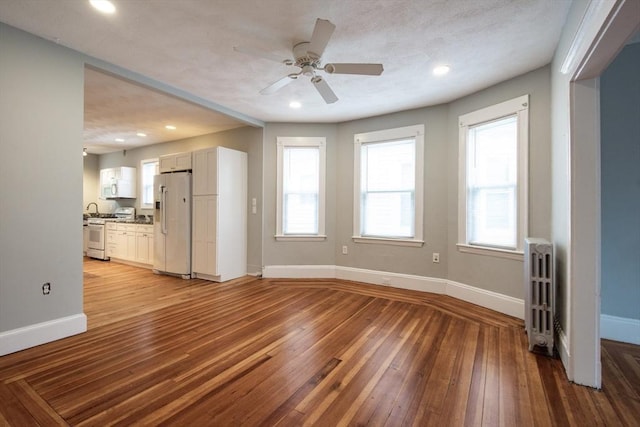 30 Partridge Ave, Somerville, MA 02145 - unfurnished living room with light wood-style flooring, baseboards, radiator heating unit, ceiling fan, and recessed lighting
