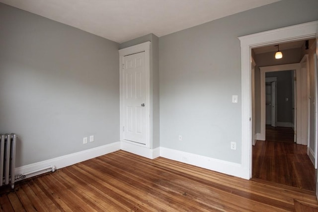 30 Partridge Ave, Somerville, MA 02145 - unfurnished room with radiator heating unit, baseboards, and hardwood / wood-style floors