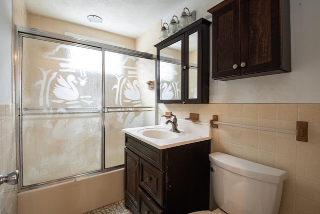 30 Partridge Ave, Somerville, MA 02145 - bathroom with vanity, combined bath / shower with glass door, toilet, and tile walls