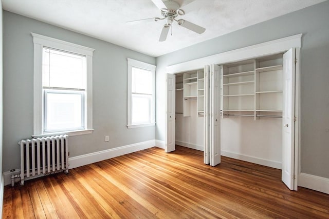 30 Partridge Ave, Somerville, MA 02145 - unfurnished bedroom with radiator, multiple closets, light wood-style flooring, and baseboards