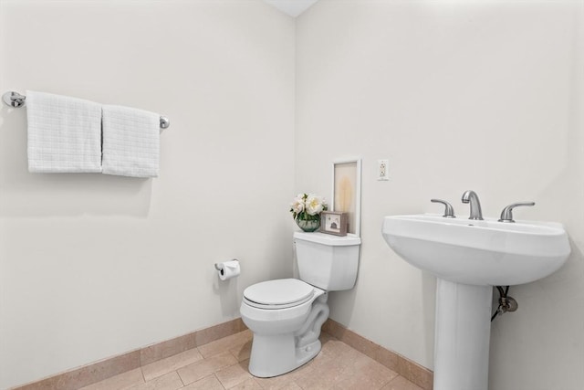 bathroom with tile patterned floors and toilet