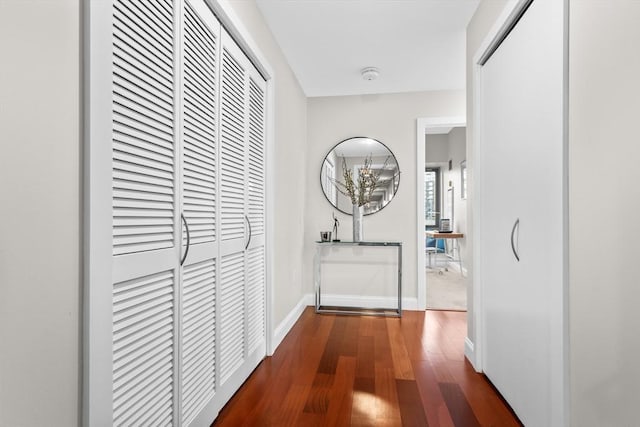 corridor with hardwood / wood-style flooring