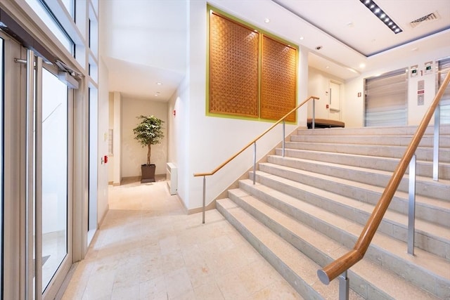 stairs featuring a high ceiling