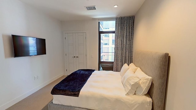 carpeted bedroom with baseboards