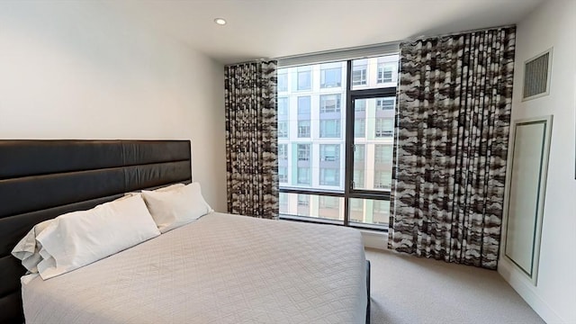 carpeted bedroom with recessed lighting