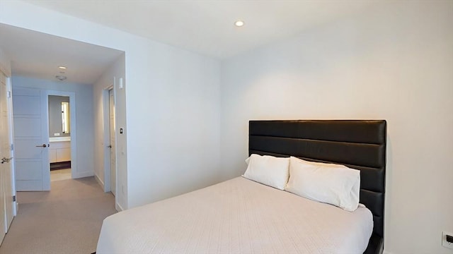 bedroom with recessed lighting, light colored carpet, and baseboards