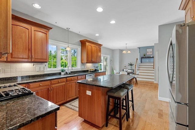 20 Hillside Dr, Georgetown, MA 01833 - kitchen with freestanding refrigerator, dishwasher, light wood-style flooring, a center island, and a breakfast bar area