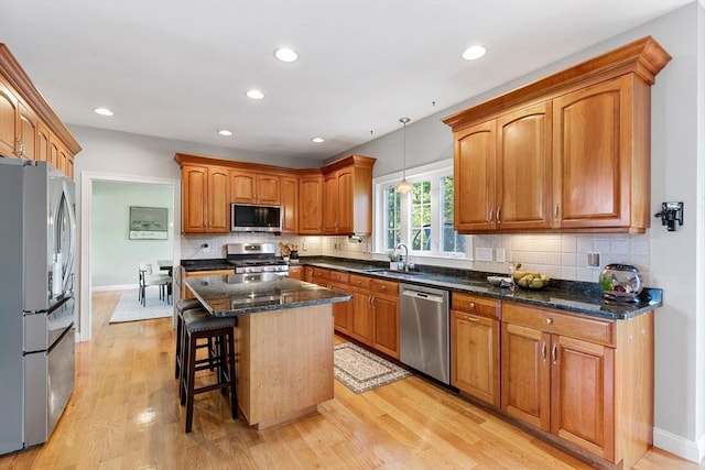 20 Hillside Dr, Georgetown, MA 01833 - kitchen featuring stainless steel appliances, tasteful backsplash, light wood-type flooring, brown cabinets, and recessed lighting