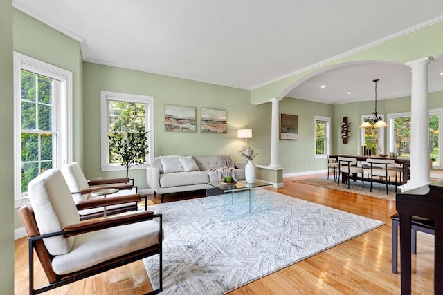 20 Hillside Dr, Georgetown, MA 01833 - living room with ornate columns, arched walkways, ornamental molding, wood finished floors, and recessed lighting