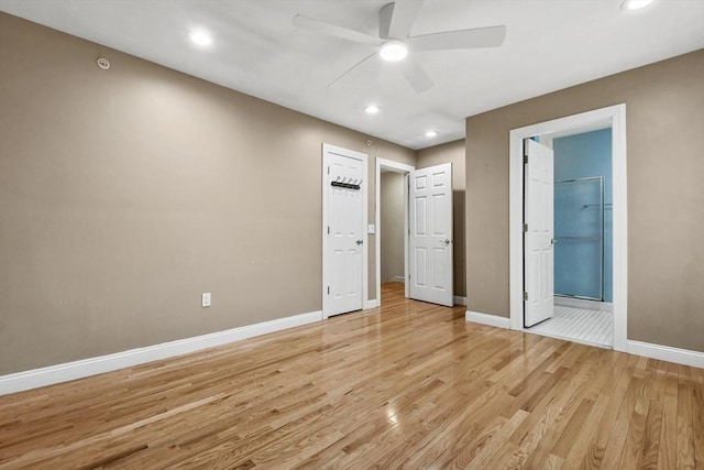 unfurnished bedroom with ceiling fan, light hardwood / wood-style floors, and ensuite bath