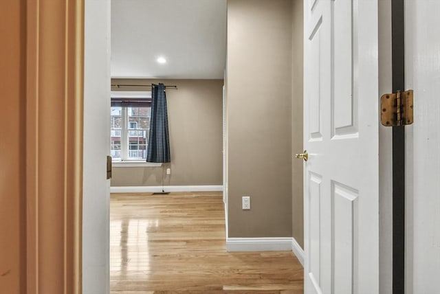 corridor with light hardwood / wood-style flooring