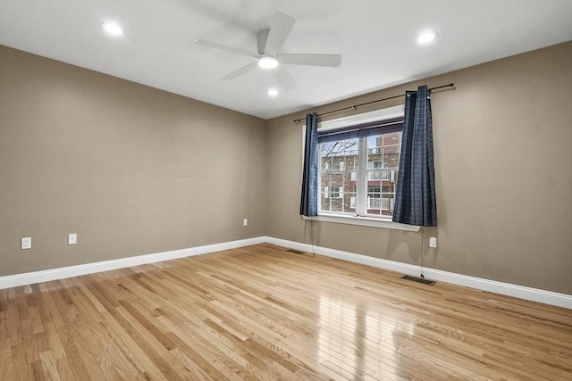 spare room featuring light wood-type flooring and ceiling fan