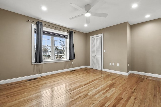 spare room featuring ceiling fan and light hardwood / wood-style floors