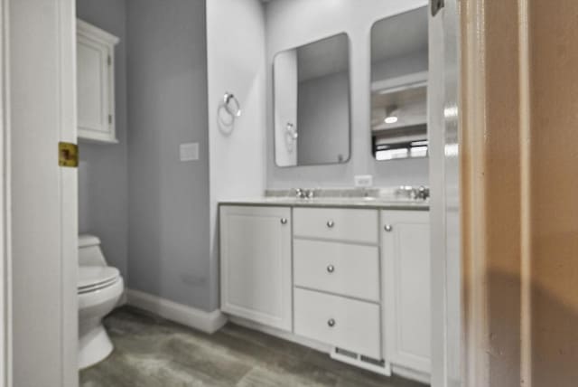 bathroom featuring vanity and toilet