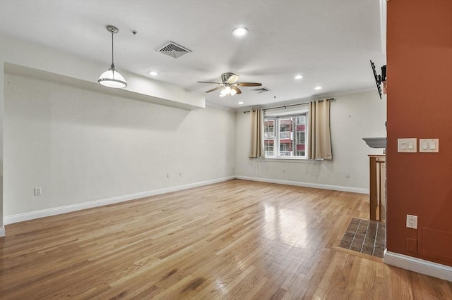 unfurnished living room featuring ceiling fan and light hardwood / wood-style flooring