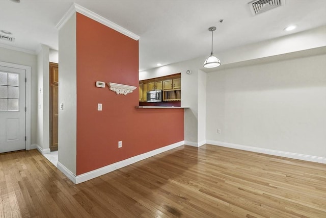 interior space featuring hardwood / wood-style floors and crown molding