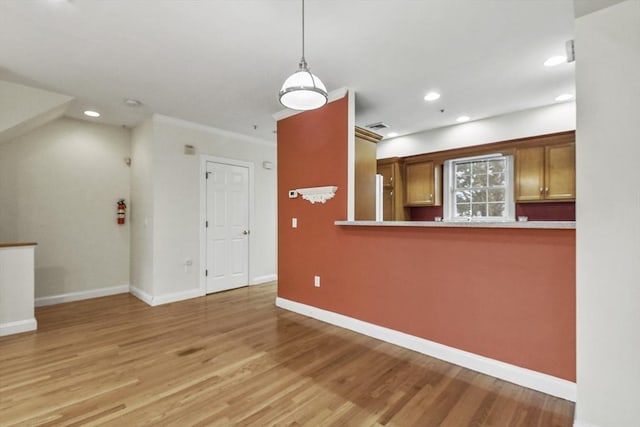 interior space with light hardwood / wood-style floors and ornamental molding