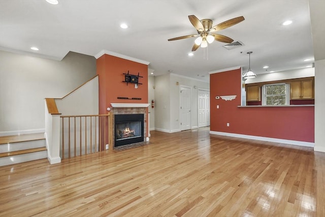 unfurnished living room with light hardwood / wood-style floors, ceiling fan, and crown molding