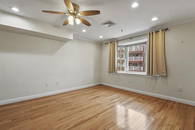 spare room featuring crown molding, light hardwood / wood-style flooring, and ceiling fan