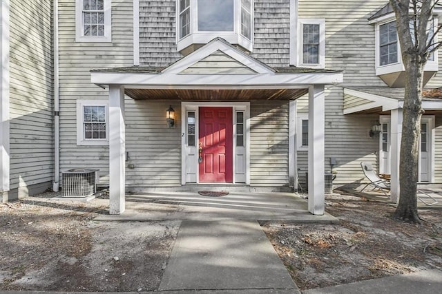 view of exterior entry featuring central AC unit