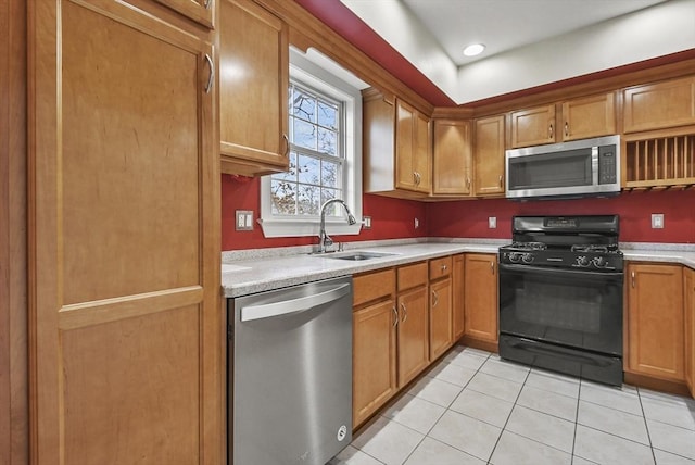 kitchen with light tile patterned flooring, appliances with stainless steel finishes, and sink