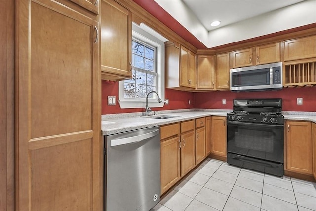 kitchen with sink, light tile patterned flooring, and appliances with stainless steel finishes