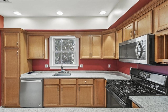 kitchen featuring light stone counters, sink, and appliances with stainless steel finishes