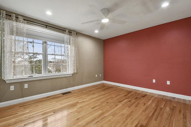 empty room featuring light wood-type flooring and ceiling fan