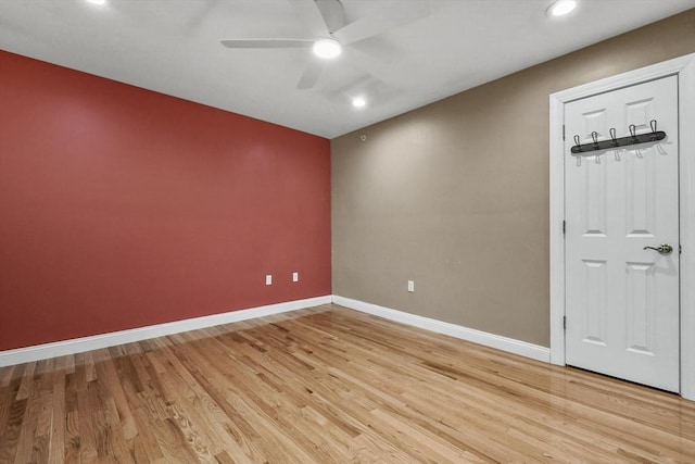 unfurnished room with ceiling fan and light wood-type flooring