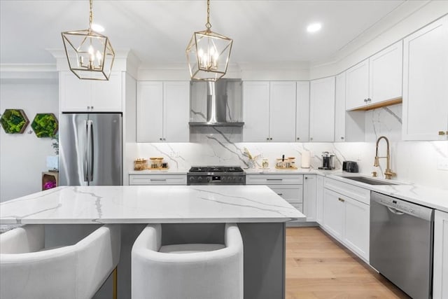 kitchen featuring a sink, wall chimney exhaust hood, a chandelier, and stainless steel appliances
