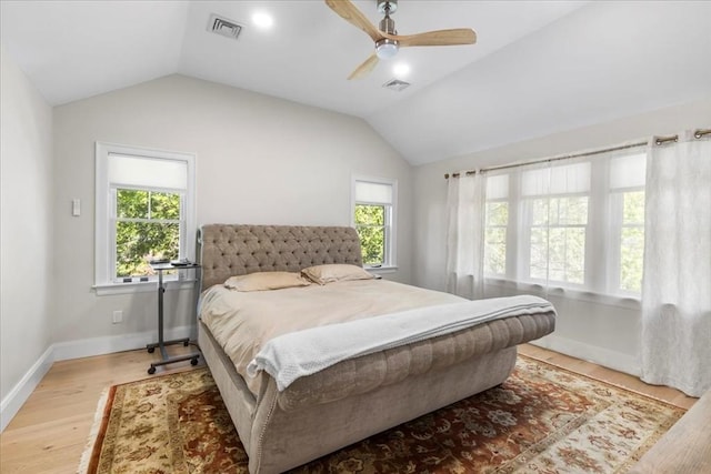 bedroom with light wood-style floors, vaulted ceiling, and visible vents