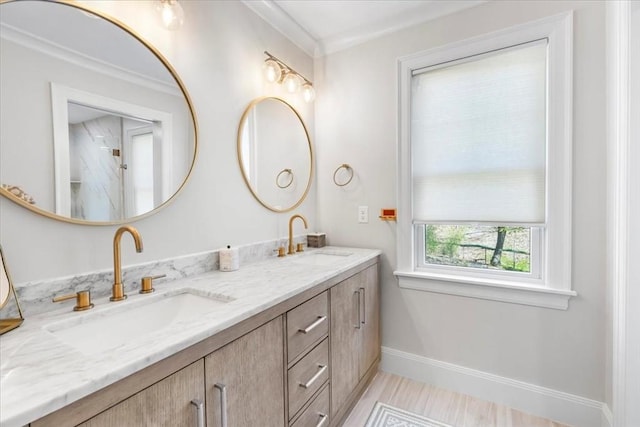 full bath with baseboards, a sink, wood finished floors, and double vanity