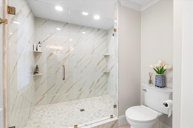 bathroom featuring recessed lighting, a marble finish shower, baseboards, and toilet
