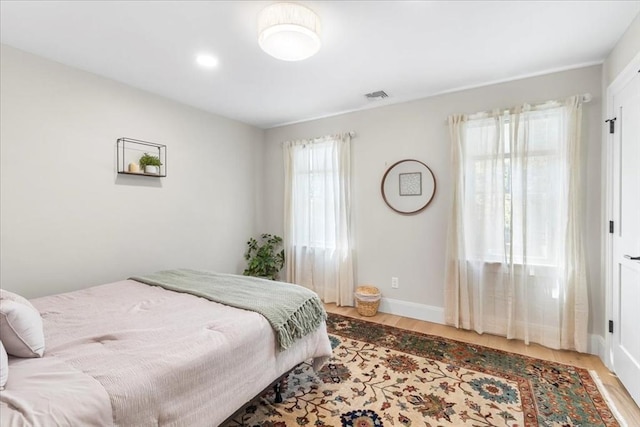 bedroom with recessed lighting, baseboards, visible vents, and wood finished floors