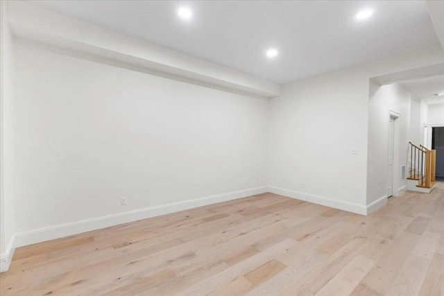 unfurnished room featuring baseboards, recessed lighting, and light wood-style flooring