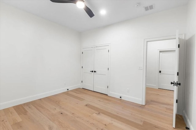 unfurnished bedroom with visible vents, a ceiling fan, light wood-style flooring, and baseboards