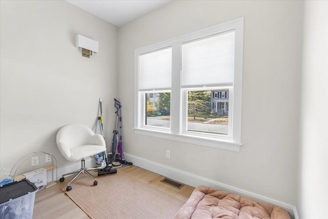 exercise room with visible vents, baseboards, and wood finished floors