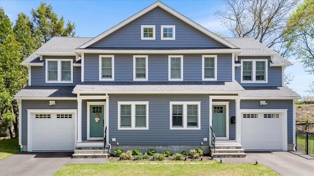 view of front of house featuring an attached garage, fence, entry steps, and aphalt driveway