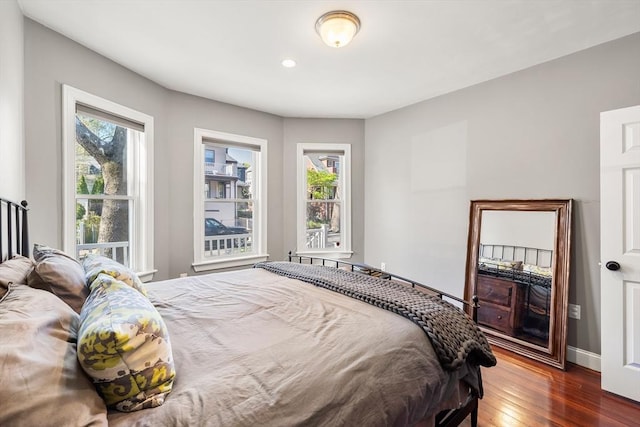 bedroom featuring hardwood / wood-style flooring, baseboards, and recessed lighting