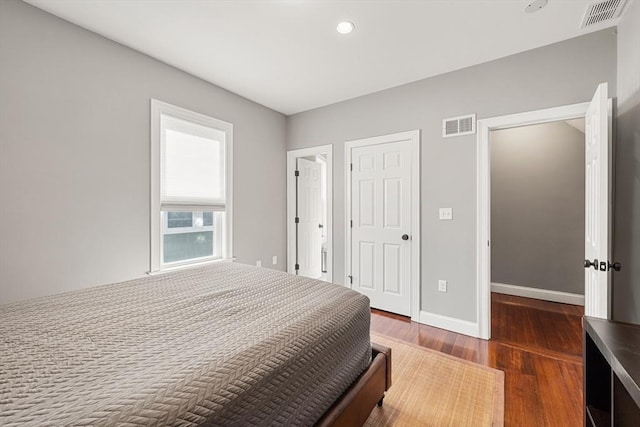 bedroom with dark wood finished floors, baseboards, and recessed lighting
