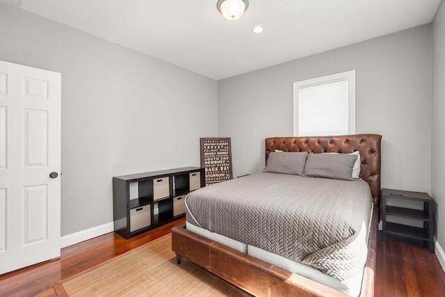 bedroom featuring wood finished floors, baseboards, and recessed lighting