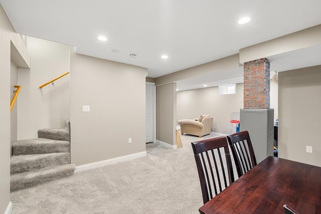 finished below grade area featuring stairway, light colored carpet, baseboards, and recessed lighting