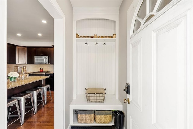 mudroom featuring dark wood-type flooring and recessed lighting