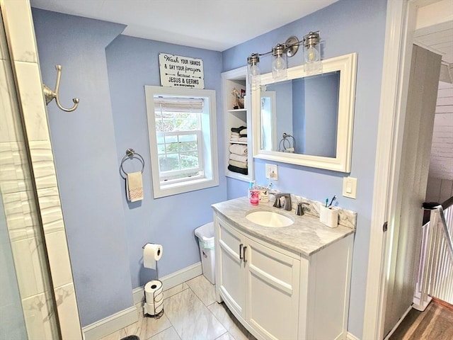 4 Randall Rd, Mattapoisett, MA 02739 - full bath with vanity, baseboards, toilet, marble look tiles, and a shower