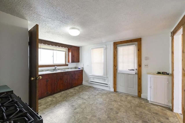 17 Westminster, Westfield, MA 01085 - kitchen with baseboard heating, a sink, light floors, light countertops, and a textured ceiling