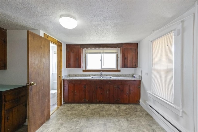 17 Westminster, Westfield, MA 01085 - kitchen with a sink, a baseboard heating unit, light floors, light countertops, and a textured ceiling