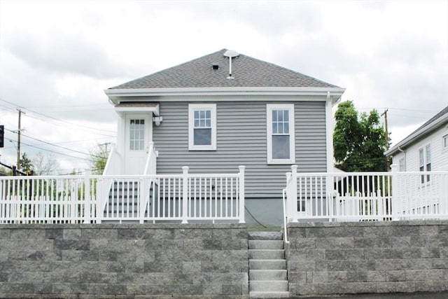 338 Sea St, Quincy, MA 02169 - view of front of house with a shingled roof and fence