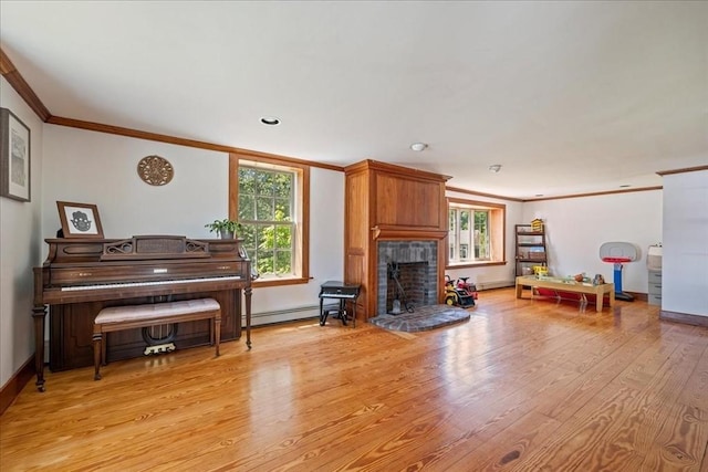 127 Main St, Norwell, MA 02061 - living area with crown molding, light wood finished floors, a baseboard heating unit, a fireplace with raised hearth, and baseboards